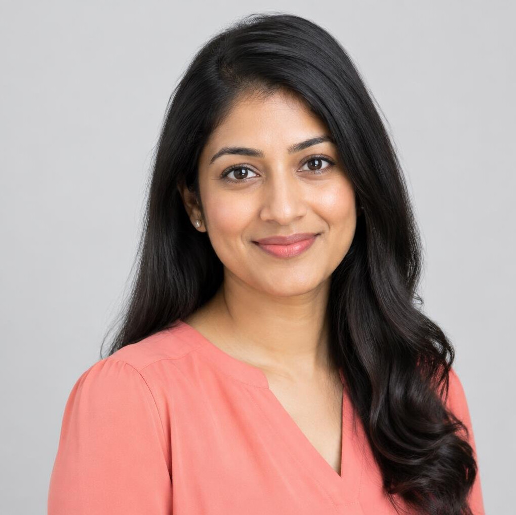 Studio portrait of an Indian Singaporean woman in her 30s in professional attire
