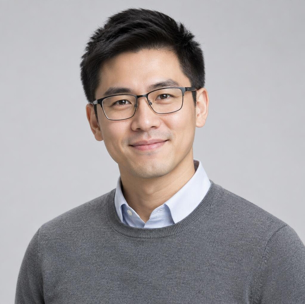 Studio portrait of a Chinese Singaporean man in his 30s wearing glasses